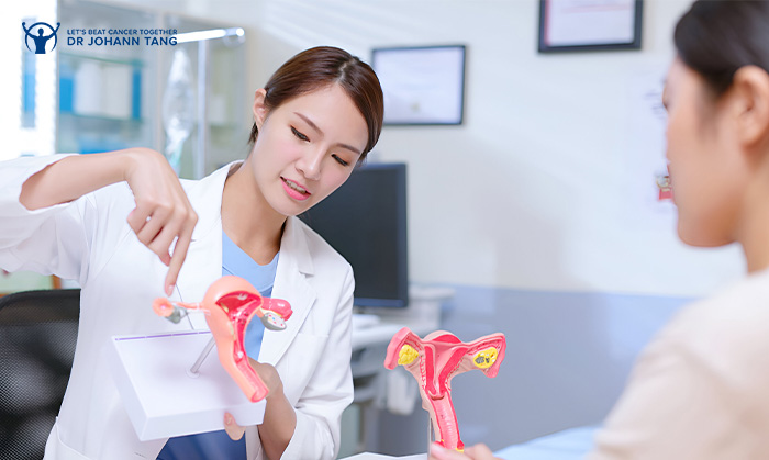 Specialist using anatomical model to explain cervical cancer differences.