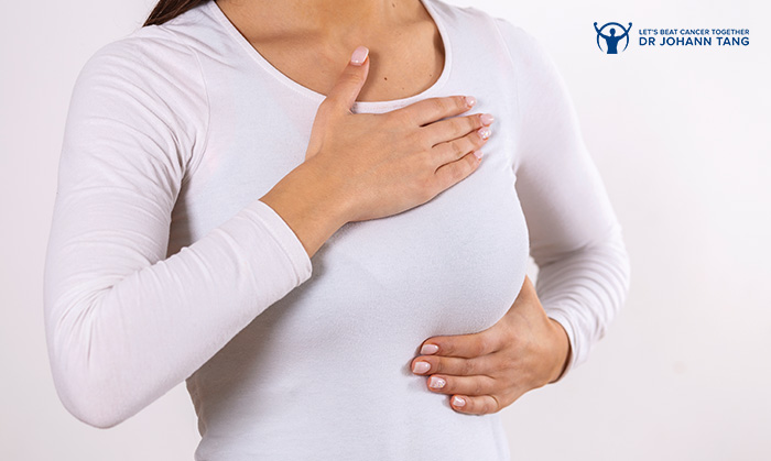 Woman performing a breast self-exam to check for lumps.
