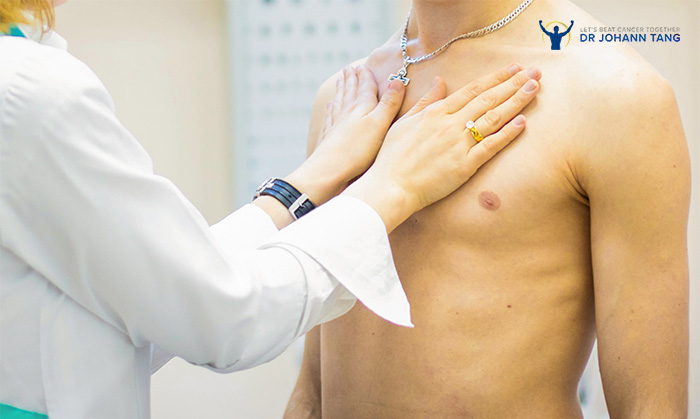 Doctor performing physical chest examination on a male patient.