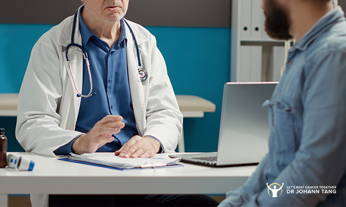 Doctor discussing diagnosis and treatment with a male cancer patient.